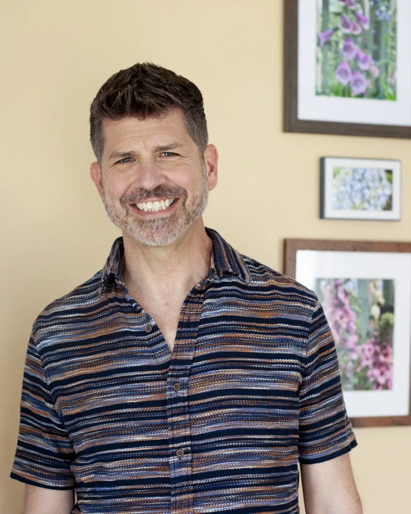 Jason Cianciotto smiling in a striped shirt.